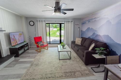 a living room with a couch and a mountain mural at Killington resort: Walk to Mountain, Biking & Pool in Killington