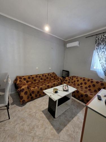 a living room with a couch and a table at Chora Residence in Khóra