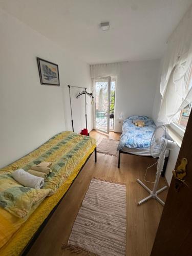 a bedroom with a bed and a chair in it at Weekendica Aljmaš in Aljmaš