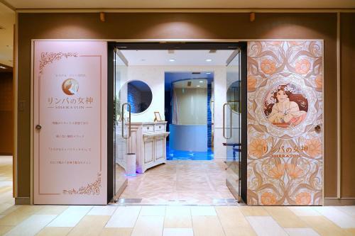 a room with a door with a bathroom in it at Sheraton Grande Tokyo Bay Hotel in Urayasu