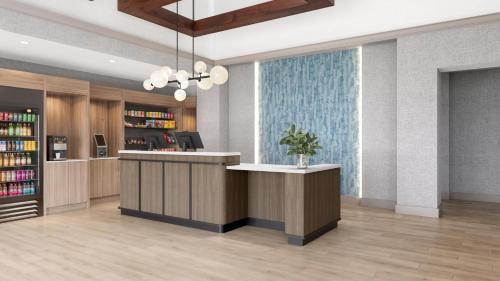 a lobby with a reception desk in a library at Hyatt Select Louisville North in Jeffersonville