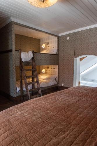 a bedroom with a bunk bed and a wooden ladder at Villa Vimmerby in Vimmerby