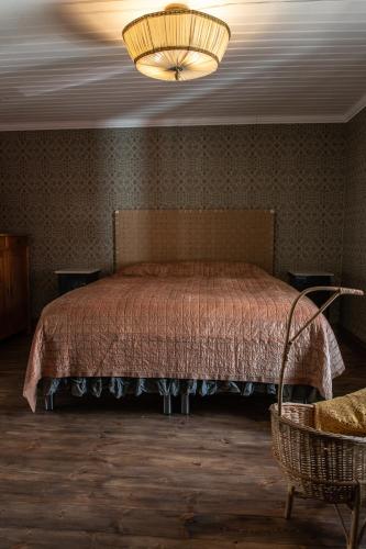 a bedroom with a bed and a chandelier at Villa Vimmerby in Vimmerby