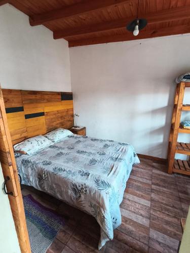a bedroom with a bed with a wooden headboard at Lo de tina in Florencio Varela
