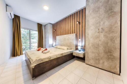 a bedroom with a large bed and a shower at Villa & Pool in Utjeha
