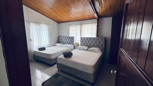 a small room with two beds and a window at GatoPardo in Montenegro