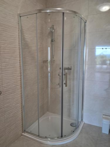 a shower with a glass door in a bathroom at Mabora in Crikvenica