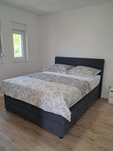 a large bed in a bedroom with a bed frame at Mabora in Crikvenica