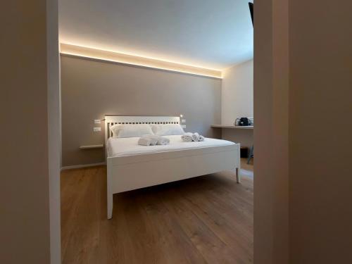 a bedroom with a white bed in a room at Annina Locanda in Corciano