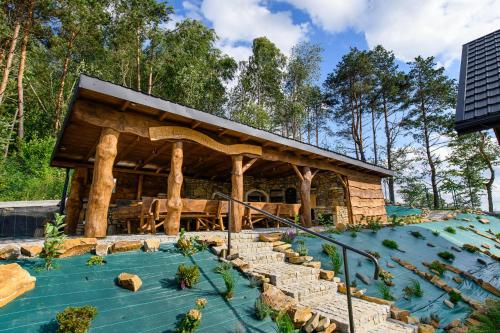 a wooden pavilion with stairs leading up to it at Kamienny Horyzont in Bereżnica Wyżna