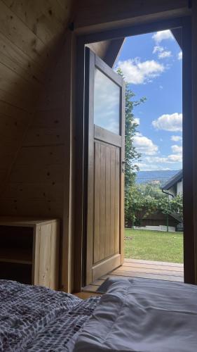a door to a room with a bed and a window at Castle view Chalet - ZemvaStays in Zgornje Gorje