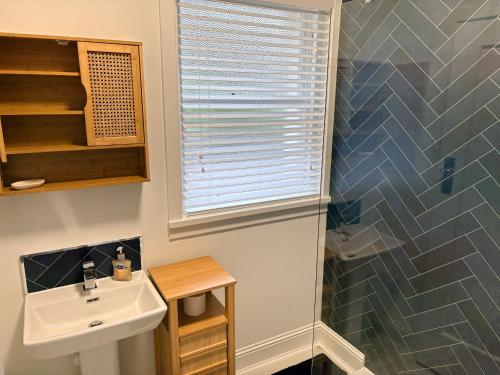 a bathroom with a sink and a shower at Myrtlebank in Pitlochry