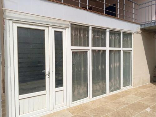 a sliding glass door on the side of a house at HUSAYN HoSTEL in Xirdalan