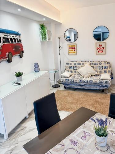 a living room with a couch and a table at Mermaid Beach in Roquebrune-Cap-Martin