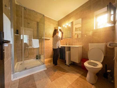 a woman standing in a bathroom looking in the mirror at Anna ByTheSea By iVAVev in Eforie Sud