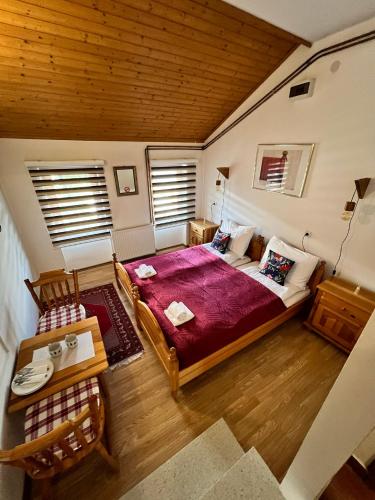 a bedroom with a large bed and a wooden ceiling at Vlašić Moon Apartments in Vlasic