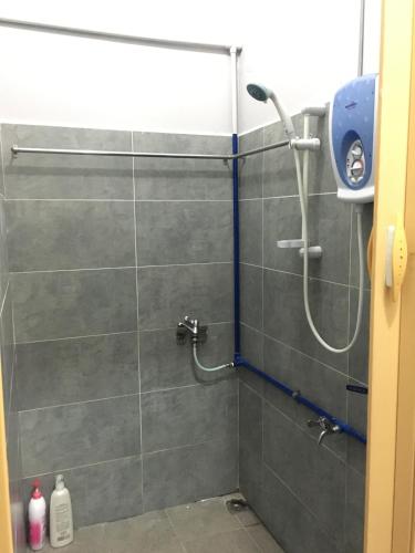 a bathroom with a shower with a shower head at Ranau Backpackers Hostel in Ranau