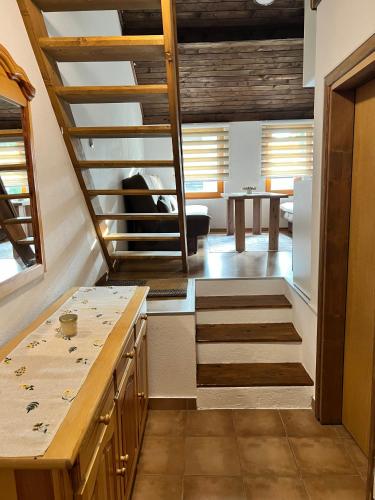 a kitchen with stairs leading to a dining room at Vlašić Moon Apartments in Vlasic
