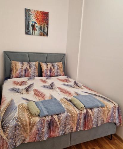 a bed in a bedroom with two pillows on it at Avenue Apartment Sarajevo in Sarajevo