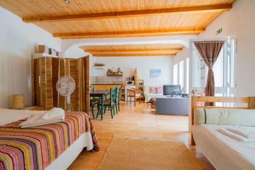 a bedroom with a bed and a dining room at Quinta dos Cochichos - Country Houses in Olhão