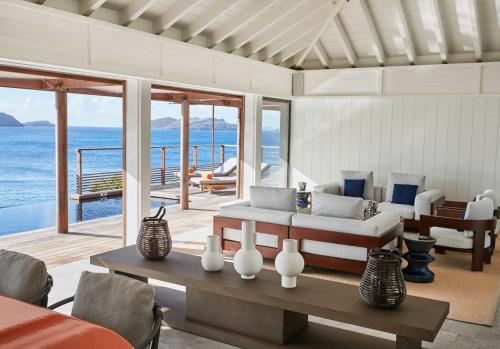 a living room with a couch and a table at Hotel Christopher Saint Barth in Pointe Milou