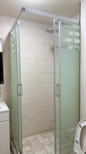 a shower with a glass door in a bathroom at Amina Hotel PREMIUM in Bukhara