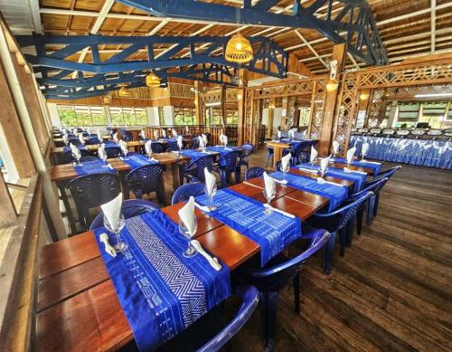 a dining room with blue tables and chairs at La Maringa El Magnifico in Libreville