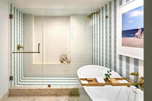 a bathroom with a tub and a shower at Omni Amelia Island Resort & Spa in Amelia Island
