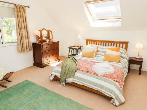 a bedroom with a bed and a skylight at The Garden Rooms in Narberth