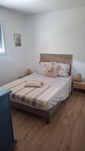 a bed with white sheets and pillows in a bedroom at Chambre d'hôtes Nova, petit déjeuner en supplément 5 euros par personne in Saint-Pair-sur-Mer