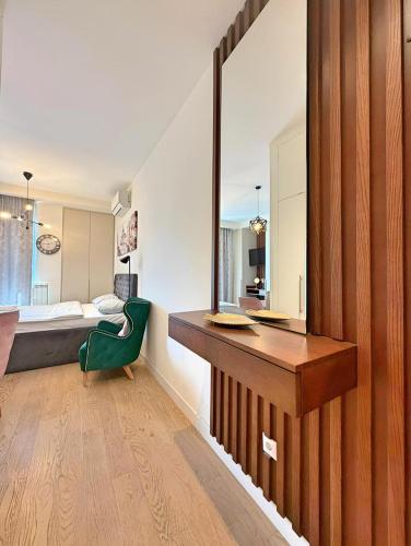 a bathroom with a desk and a bed in a room at BW Premium One-Bedroom Apartments in Belgrade