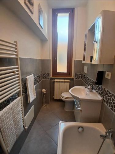 a bathroom with a sink and a toilet and a tub at Marruvium 1937's in Avezzano
