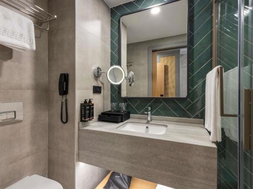 a bathroom with a sink and a mirror at Mercure Antalya Konyaalti in Antalya