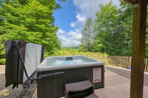 a hot tub in a gazebo with a chair at Charming 4BR Cabin - HOT TUB - Mountain View in Hoyes Run