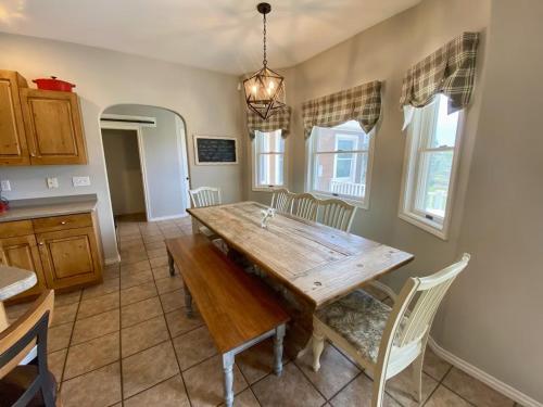 a dining room with a wooden table and chairs at The Gathering Place home in Montrose