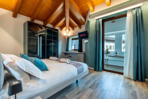 a bedroom with a bed and a large window at Casa Sgubin in Cormòns