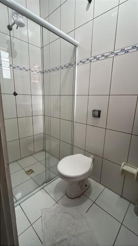 a bathroom with a toilet and a shower at Pousada Vila Pitanga in Santos