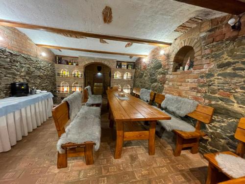 a dining room with a long wooden table and benches at Penzion Belle Donne in Znojmo