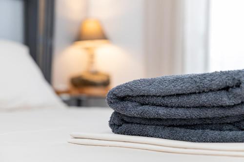 a pile of towels sitting on a table in front of a mirror at Vila Petro in Evkarpía