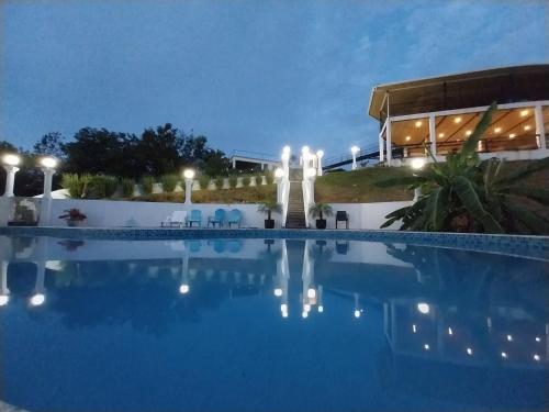 a large swimming pool at night with lights on it at Casa Blanca Inn in Torio