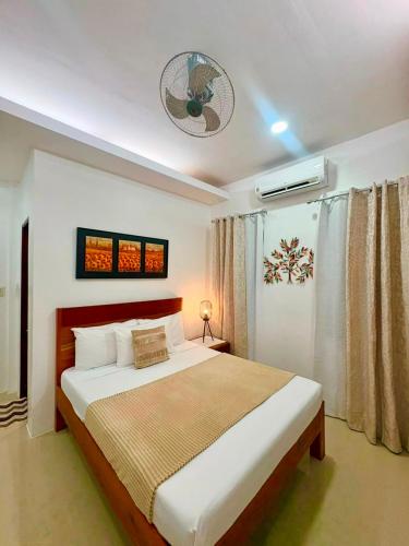a bedroom with a large bed in a room at Ramz Residence in El Nido