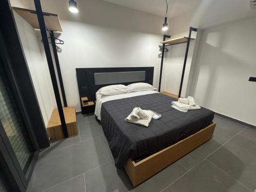 a bedroom with a bed with two towels on it at Fra Rooms in Taormina