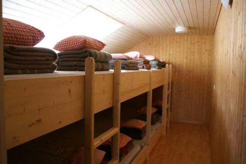 a row of bunk beds in a wooden room at Gasthaus Klausen Ranch in Urnerboden