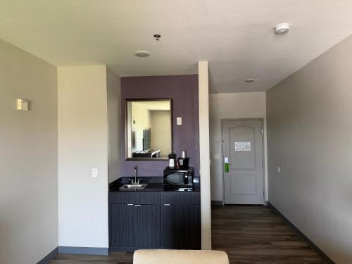 a kitchen with a sink and a counter top at La Quinta by Wyndham DFW Airport West - Euless in Euless