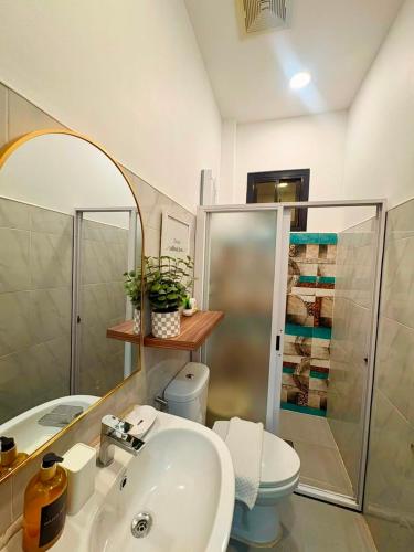 a bathroom with a sink and a toilet and a shower at Ramz Residence in El Nido