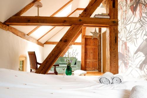 a bedroom with a bed with two towels on it at Wronki- mazurski spokój in Wronki