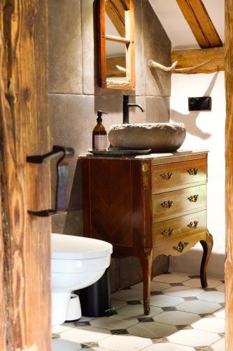 a bathroom with a sink on a wooden dresser at Wronki- mazurski spokój in Wronki