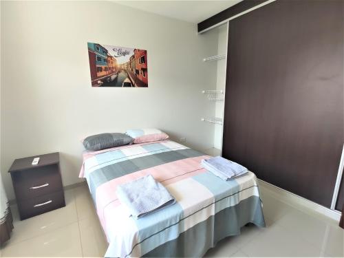 a bedroom with a bed and a picture on the wall at Casa Barcelona in Santa Cruz de la Sierra