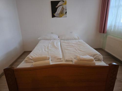 a bed with white sheets and pillows on it at Hotel Zur Buche 24h Check-in, Free in Bockhorn