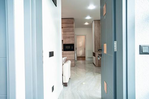 a hallway with a living room with blue walls at ANDE Apartments Hotel in Gonio